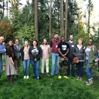 a row of people standing in the grass.