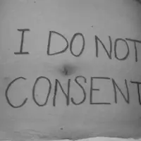 A belly of a white person with the words I do not consent.