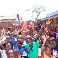 Empowered Dreams Initiative founder Samwel Otachi with kids during a feeding program in Korogocho slums Nairobi