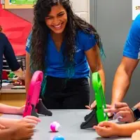 Staff and members enjoying social recreation activity (playing a game).