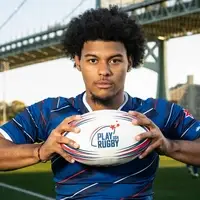 Young man holding rugby ball