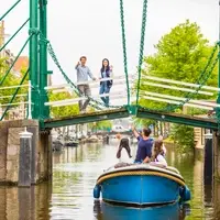 Leiden is a traditional medieval town with canals throughout.  You will definitely see at least one windmill on your way to class too!
