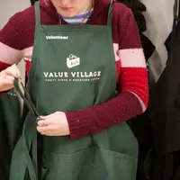 Woman wearing an Arc's Value Village green apron.