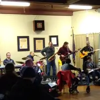 Kevin and Tim are on stage, playing with their Out of the Ashes bandmates.