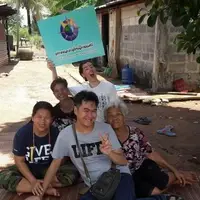 group of five people of all ages sit together and pose for a photo