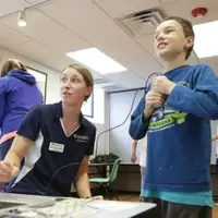 Student working with a child