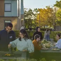 Students preparing a barbecue outside accommodation