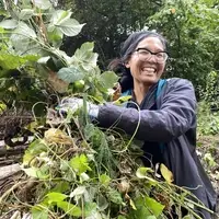 women pulling blackberry