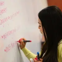 Student writing on a white board