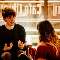 Student in discussion with another student in front of window