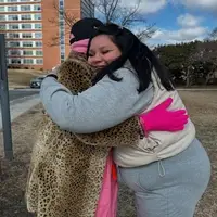 Volunteer hugging a shelter resident