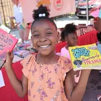 Child showing the books that she selected