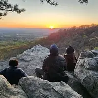Youth sitting on a rocky overlook in the Blue Ridge mountains