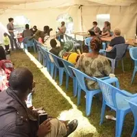 A team of Canadian doctors and local clinical officers collaborate to screen and treat a patient during a Cheherma Foundation medical camp in Kibera, Nairobi.