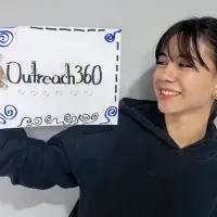 Nicaraguan teenage female smiling holding sign that says Outreach360