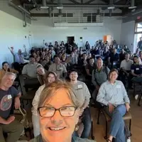 Gena Bentall with a packed audience at a sea otter research meeting.