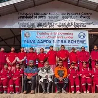 Young women and men in red uniforms pose in two rows outside the Emergency and Disaster Management Resource Centre.
