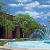 Library next to fountain with another academic building in the background.