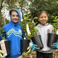 Kids holding plants