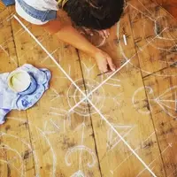 Wooden surface painted with white design.