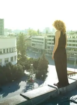Woman standing at the top of the building.