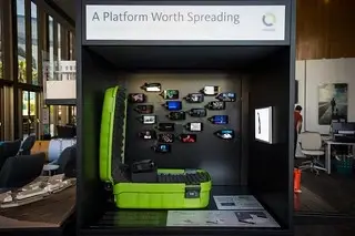A projector in a tiny room with small tv screens on the wall.