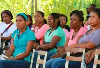 A group of people sitting and watching something in front of them.