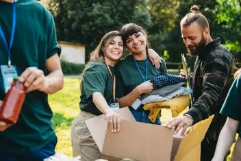 photo of volunteers cleaning up trash at a park