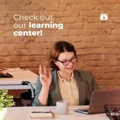 person in a video meeting smiling and waving at a laptop
