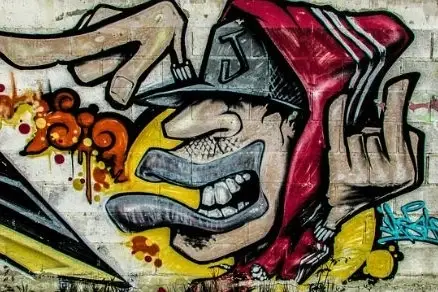 Street art of a person in a hoodie.