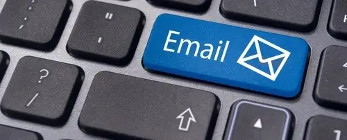 A keyboard with a key that has an email icon on it.