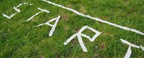 The word start spelled out in tape on the grass.