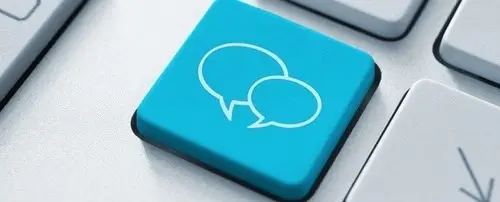 A keyboard with a key that has speech bubbles  on it.