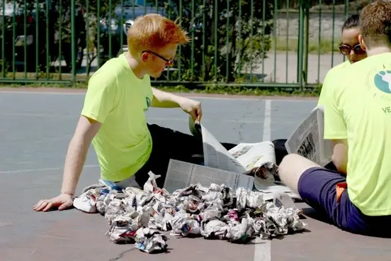 A person folding newspapers.