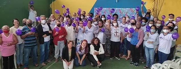 Grupo de pessoas com balões em roxo