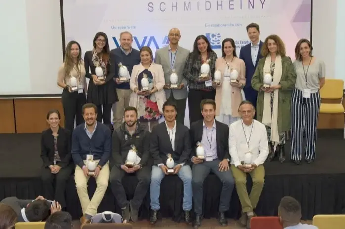 A group of people holding plaques on a stage.