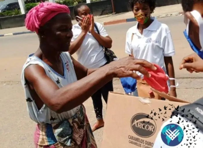 Volunteers giving out masks.
