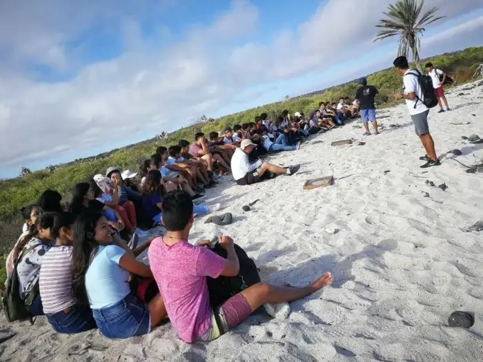 Group of people sitting on sand