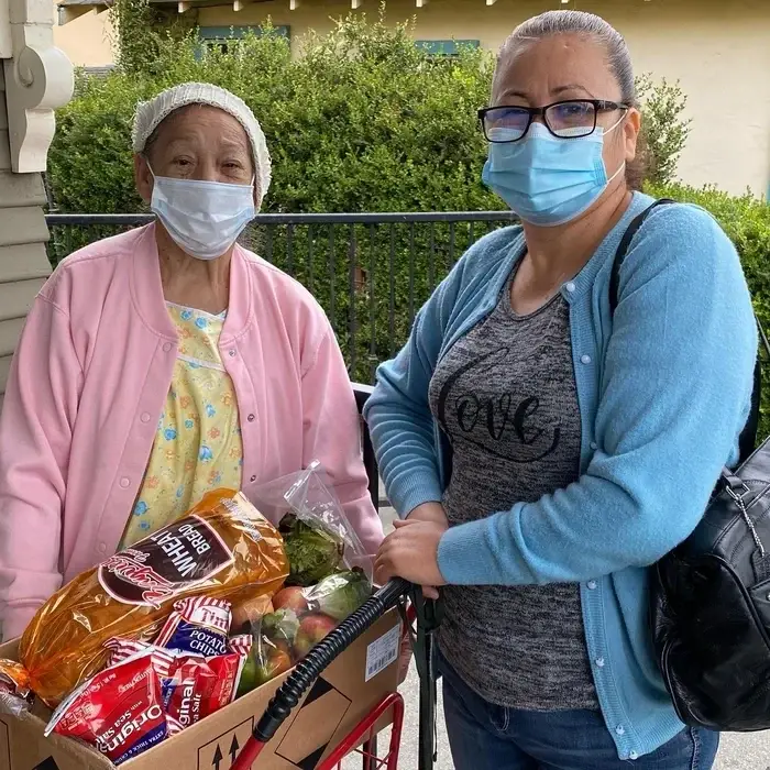 Volunteer with Pajaro Loaves and Fishes poses for a photo with a client
