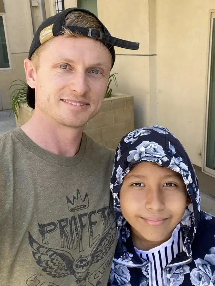Image of Chris volunteering with a student, Diego