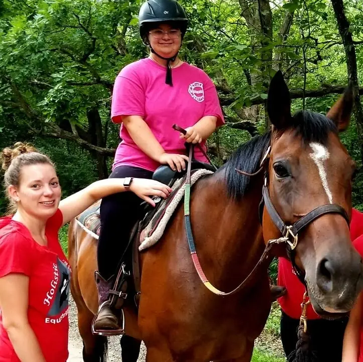 Volunteer at therapeutic horseback riding facility