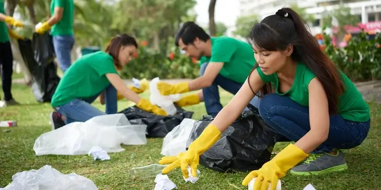 Volunteers help pick up trash at a local park
