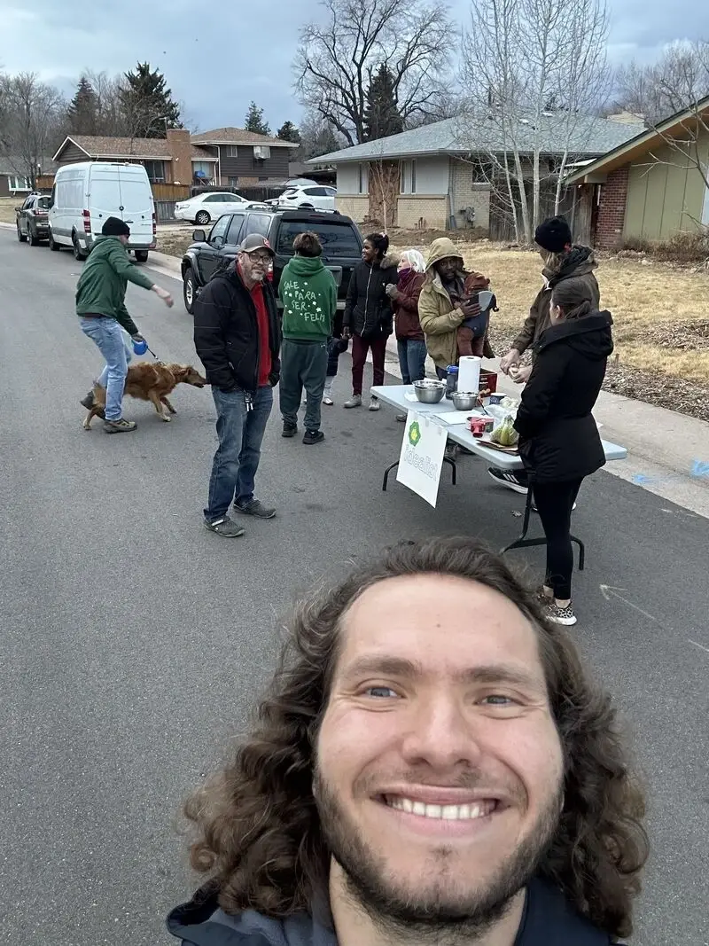 Jet smiles for a photo with neighbors who showed up for his local Idealist Days event.