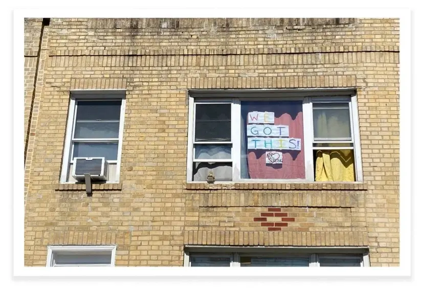A window with the phrase, "We got this" taped on the inside of it.