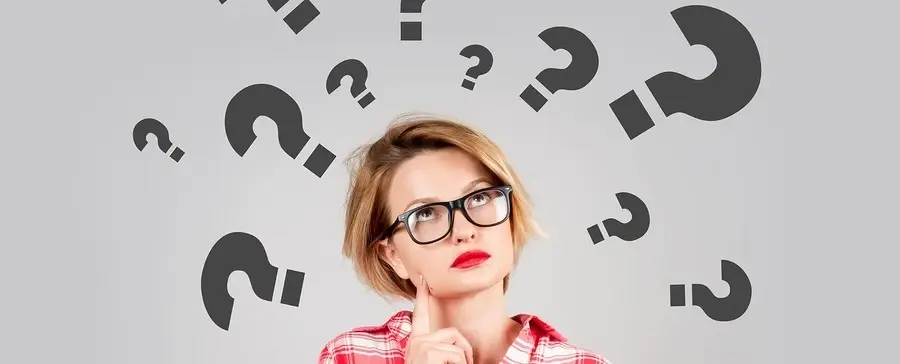 A woman thinking with question marks around her.