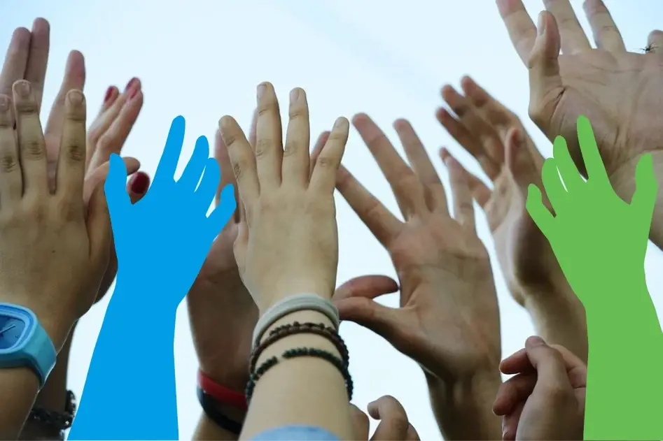 several colorful hands reaching toward sky