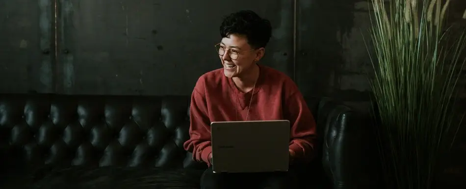 woman sitting on couch with computer