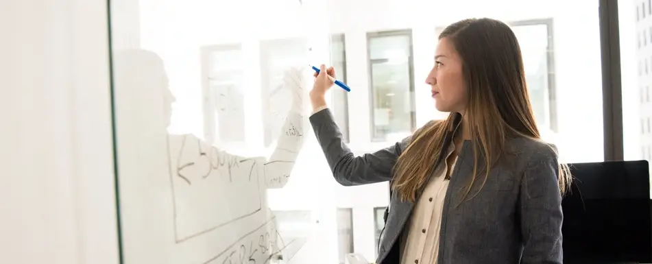 woman writing on whiteboard