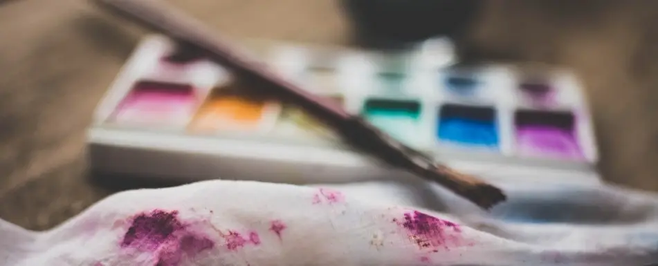 A paint brush and a paint palette.