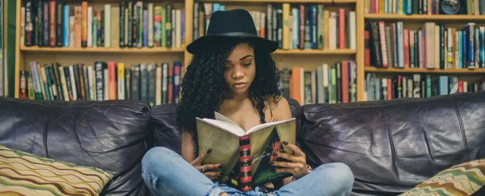 woman reading a book about self improvement